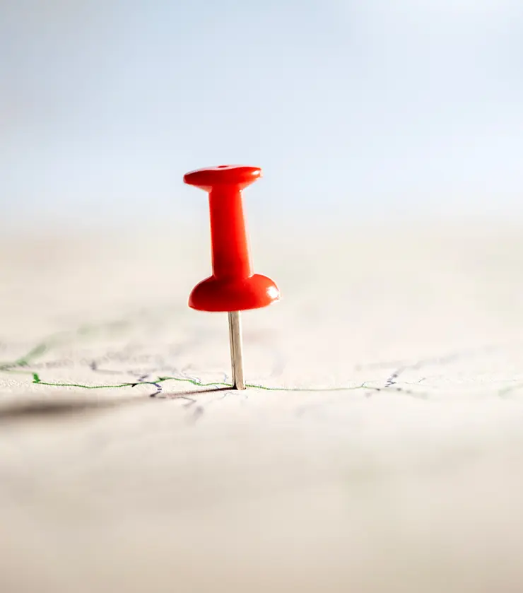 Map with red pushpin inserted
