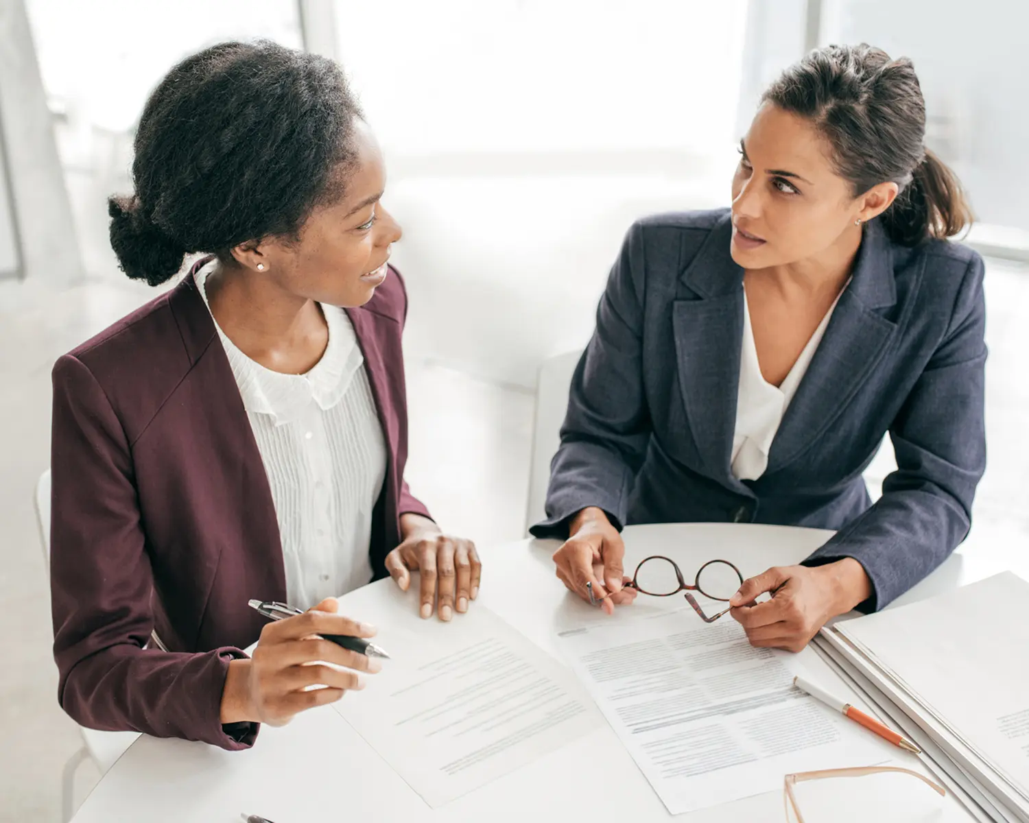 Colleagues reviewing paperwork in an office setting.