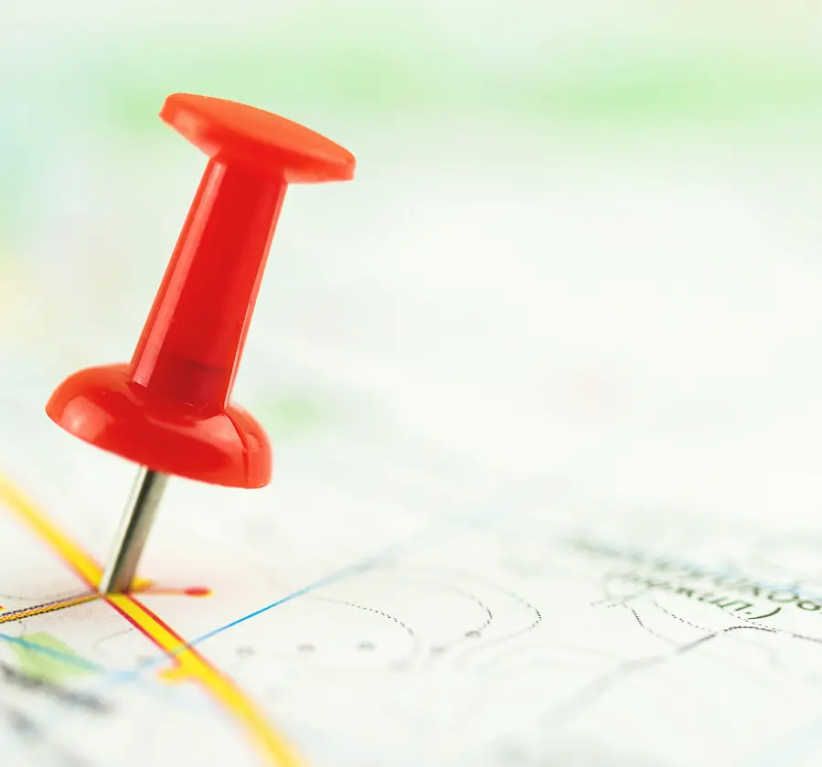 Pushpin indicating point on paper map