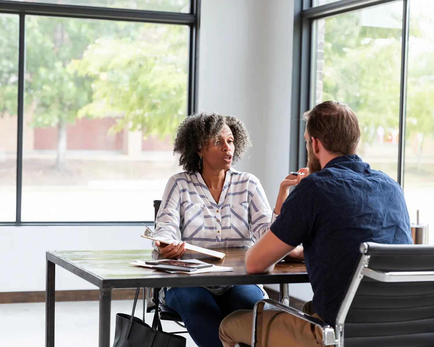 Professional conversation in bright office setting