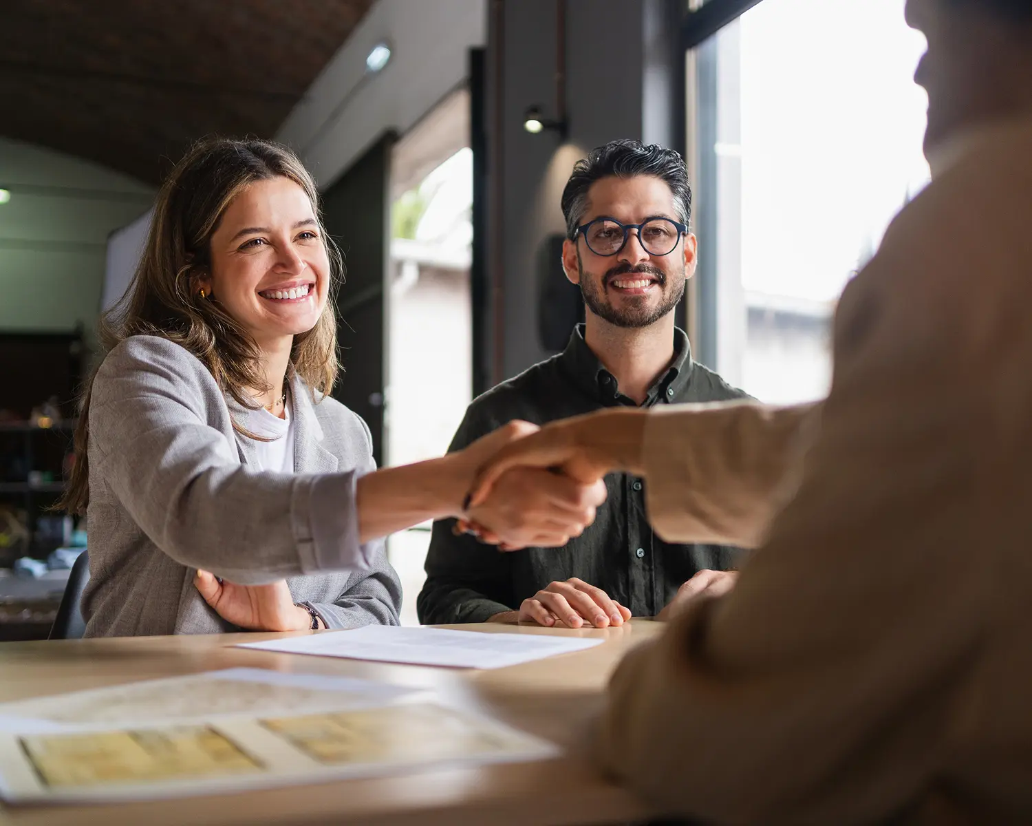 Professional handshake in a bright office