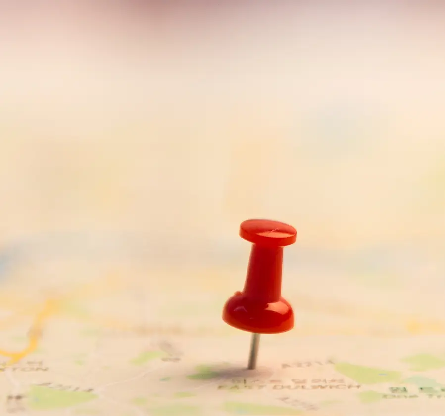 Pushpin stuck into a paper map