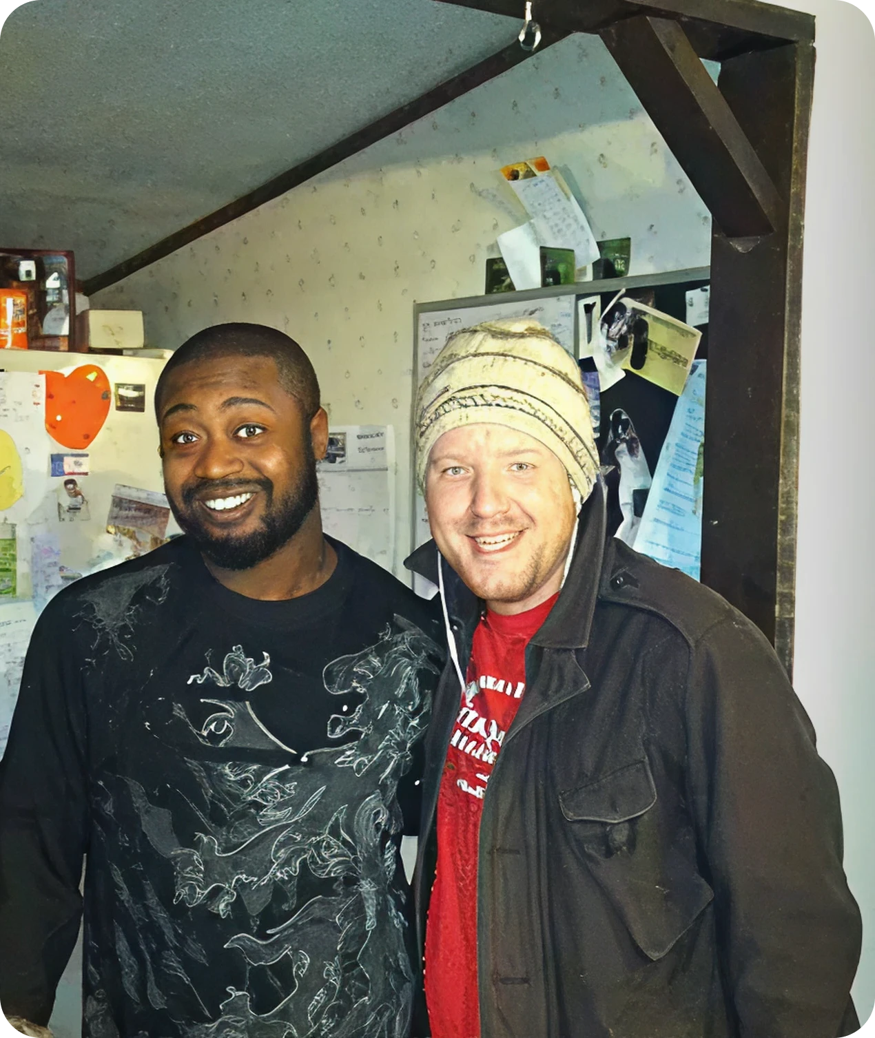 Two friends smiling in a kitchen